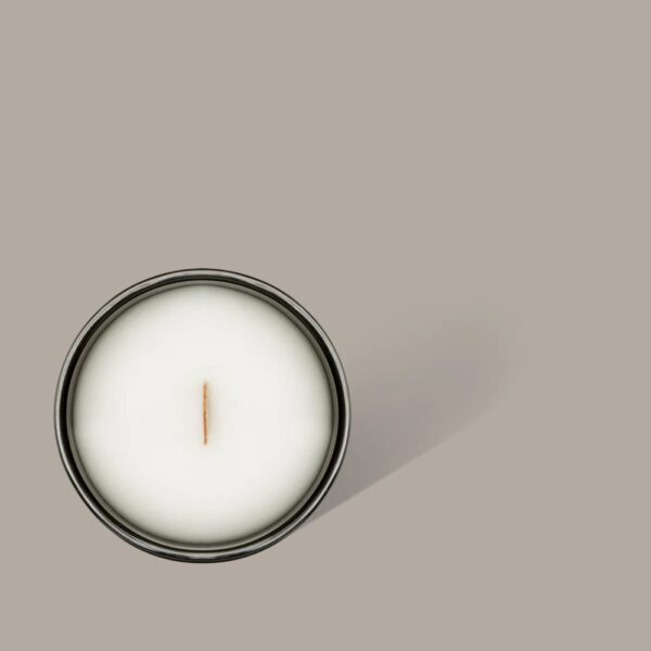 Top view of a wax candle in a jar.