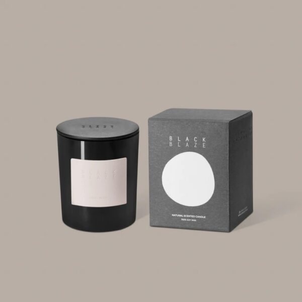 A cylinder-shaped jar of candle placed next to its box container.