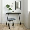 SKAGERAK Georg Console Table, Black Oak in a Hallway with a Hanging Mirror