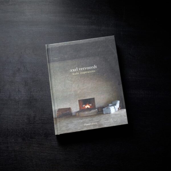 Front cover of Axel Vervoordt's Coffee Table Book placed on a hardwood table.