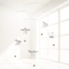 FLENSTED 5 Guardian Angels hanging from the ceiling in a soft lit room with white windows