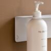 Close up of DESIGNSTUFF Shelf w/ Single Soap Dispenser Holder in White on a brown background