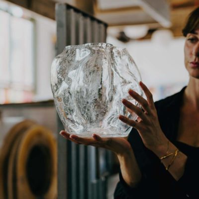 NEW WORKS Blaehr Vase Large, Clear Glass in the hands of a woman.