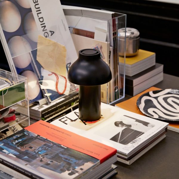 Black HAY portable table lamp displayed on a coffee table