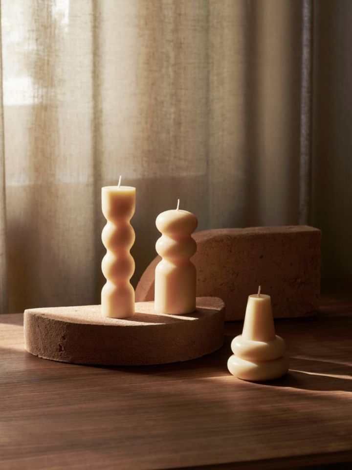 A set of ferm LIVING Torno Candles alongside a beige curtain