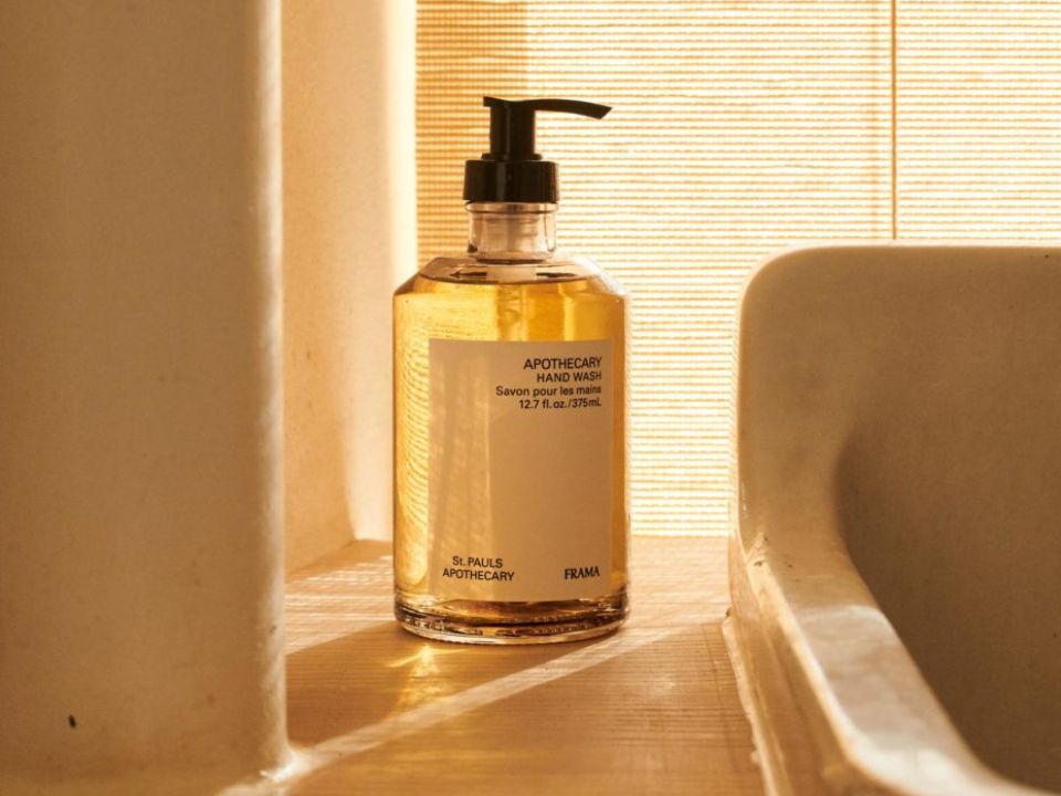 The FRAMA Apothecary Hand Soap styled in a light infused bathroom