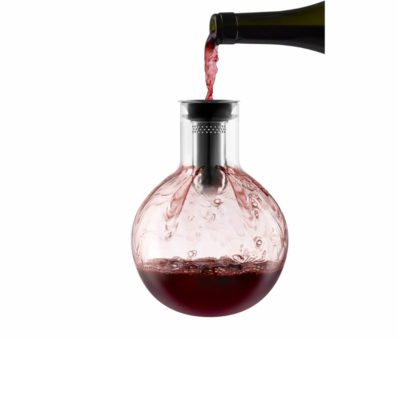 Studio lighting, perspective view of a round-shaped wine aerator bottle being poured with wine
