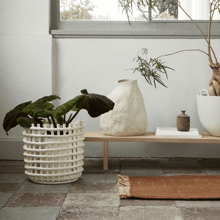 This photo illustrates the 2023 design trend of Woven Textures, featuring a number of home decor products from ferm LIVING, including the woven ceramic basket and vulca vase.