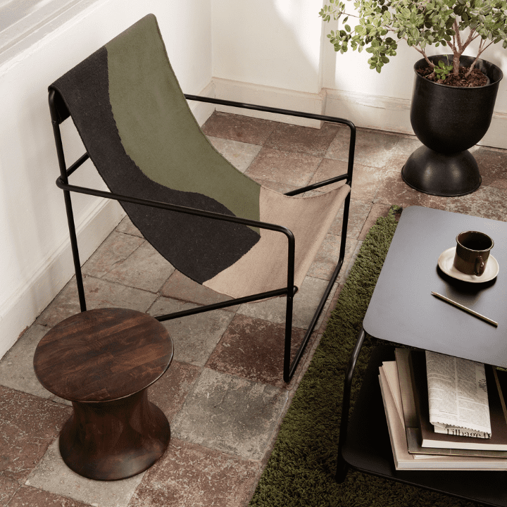 This photo illustrates the 2023 design trend of Sustainable Furniture, and features the ferm LIVING Desert Lounge chair in the Dune pattern.