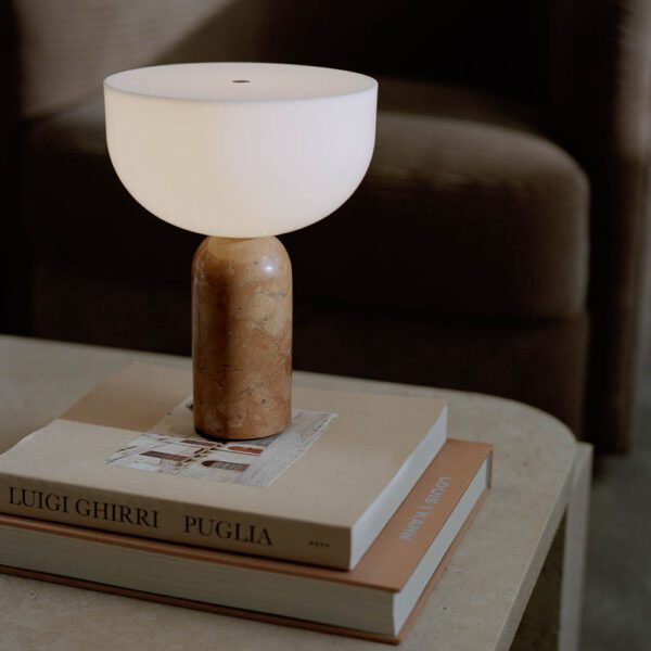 New Works Kizu portable lamp breccia pernice marble and designer books