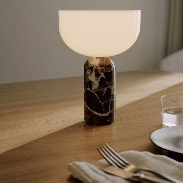 New Works Kizu portable lamp rosso levanto marble on a dining table