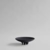 Dark brown bowl shaped tray elevated on conical shaped feet