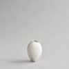 Studio photography shot of a white, droplet shaped vase