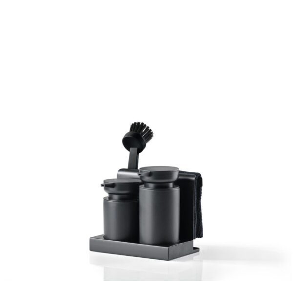 White background, studio image, perspective view of black-coloured kitchen cleaning tool including a round-shaped brush with a handle, soap dispensers, and gathered in one container.