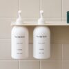 Sand DESIGNSTUFF Shelf with Dual Soap Dispenser Holder in a bathroom with white tiles