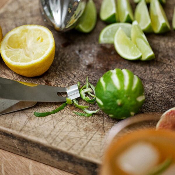 Isometric view of lime and lemons etched with canal-like patterns using a channel knife