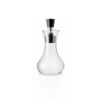 White background, studio lighting, perspective view of a transparent, glass dressing shaker with a black silicone fixed on its spout.
