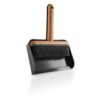 White background, studio lighting, perspective view of a small, wooden brush attached to a black plastic dustpan.