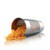 White background, studio lighting, perspective view of a stainless steel, canister-shaped grating bucket with shredded carrots spilling out.