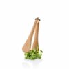White background, studio lighting, perspective view of a wooden kitchen tong picking green leafy vegetables.
