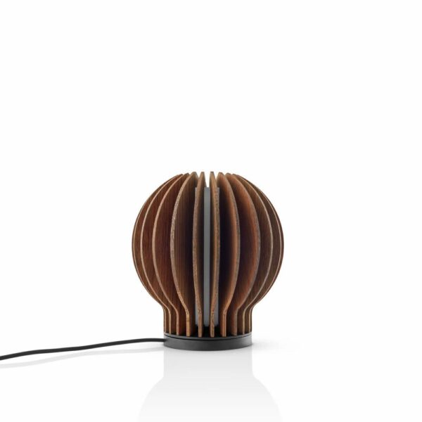 White background, studio lighting, perspective view of bulb-shaped, wooden, dark oak lamp mounted on its charging base.