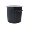 White background, studio lighting, perspective view of a small black storage and garden bin with handle.