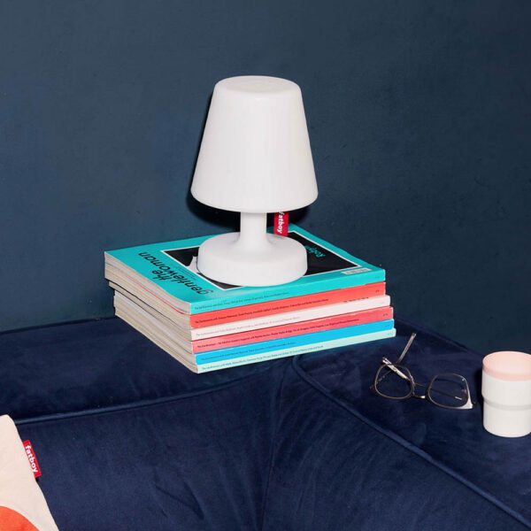 Edison the petit table lamp by Fatboy on top of the books.
