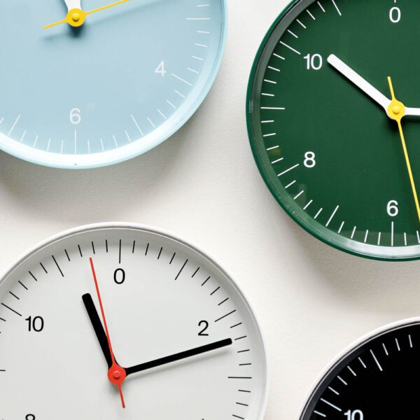 A group of wall clock in white, green, black, and soft blue.