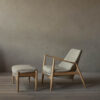 An image of the Seal lounge chair in oak and beige with the matching footrest or stool.
