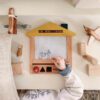 A house shaped wooden drawing board with magnetic stamps made from FSC certified beech wood.