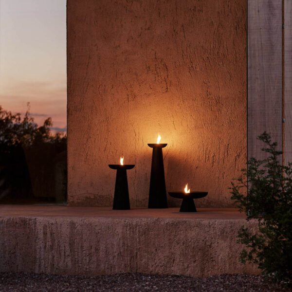 The outdoor flame made from powder-coated steel Meira Oil Lantern by Menu in black with four different sizes.