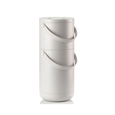 White background, studio image of a tall, grey, cylindrical trash bin with a pail-type handle.