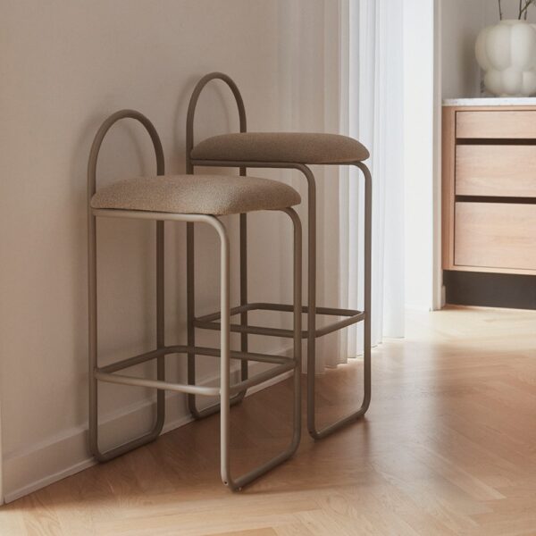 Natural lighting, perspective view of two stools backed against a wall