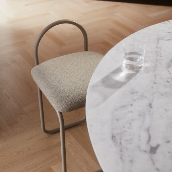 Natural lighting, perspective view of a chair placed next to a table