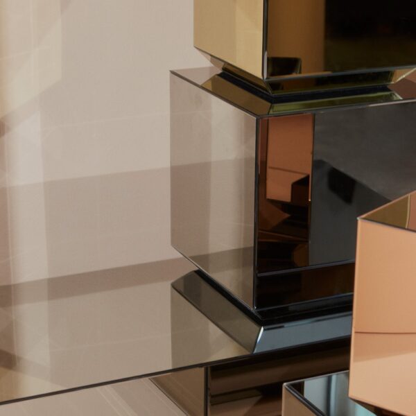 A stack of different-sized and coloured mirror tables