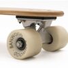 Close up of a skateboard's underside showing its trucks and wheels