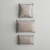 Three differently shaped cushions placed in a row.