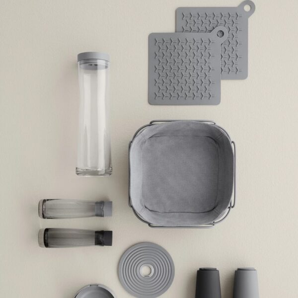 Top view of various kitchen accessories and a bread basket.