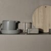 An assortment of pots, jugs, thermo glasses, and cutting boards.