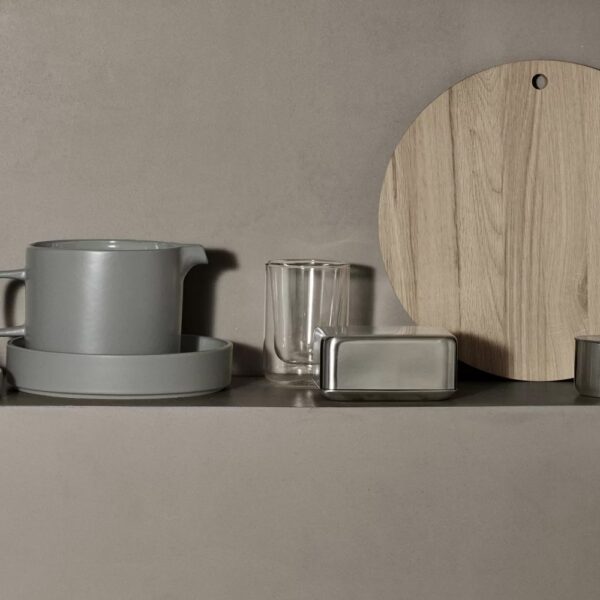 An assortment of pots, jugs, thermo glasses, and cutting boards.