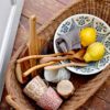 The large serving spoon made from acacia wood in a rattan picnic basket.