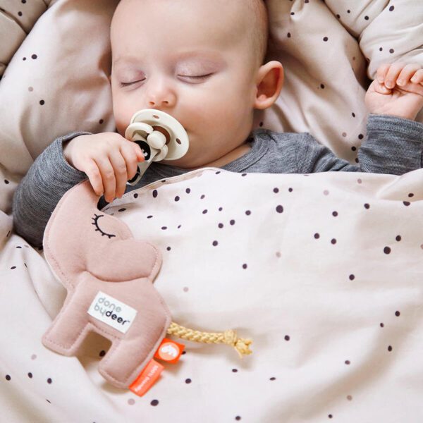 A baby with Cozy keeper Elphee with Velcro clip and an elastic loop to attach pacifiers.
