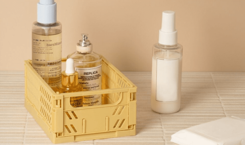 A collapsible storage crate holding bathroom cosmetics