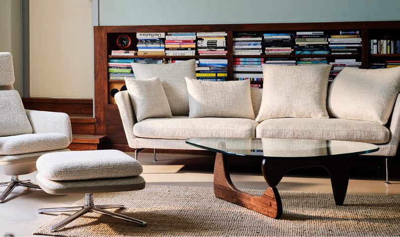 The iconic walnut Noguchi coffee table in a living room space.