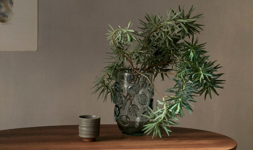 The ferm LIVING Lump Vase, housing a number of leafy green branches. 