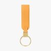 A packshot of Loop keychain in orange with a quick-snap lock system.