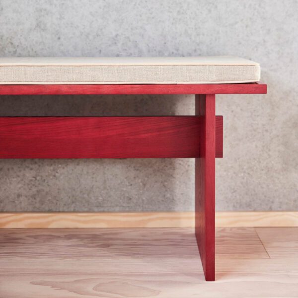 A zoomed image of Asa bench cushion on a red bench.
