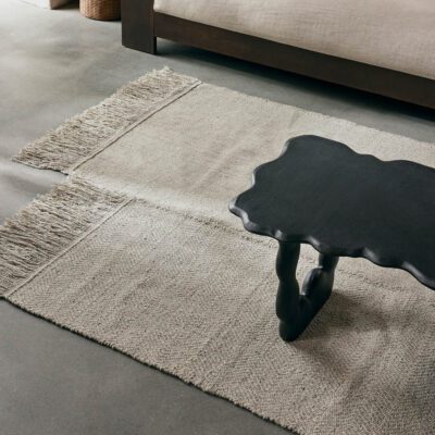 The handwoven Alter Rug has a unique and distinctive shape, that makes a captivating statement.