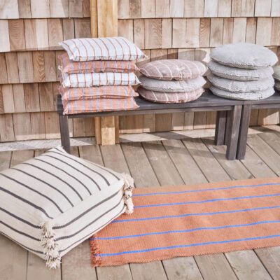 Lina Recycled Polyester Pouf for indoors and outdoors with stripes and fringes on the sides.