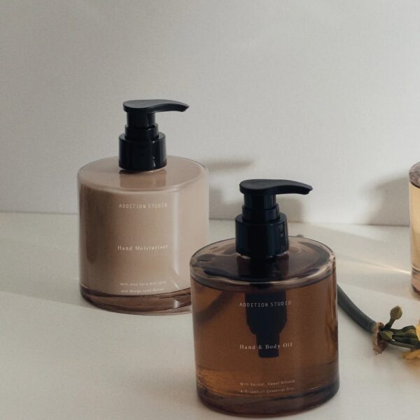 Studio lighting, perspective view of two bottles of hand moisturisers placed side by side.